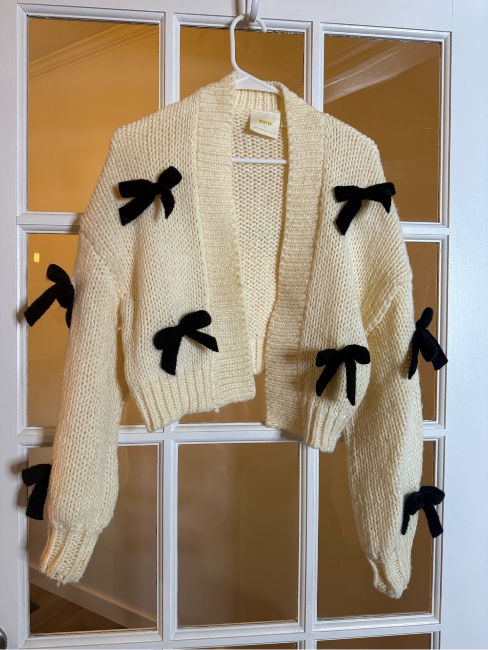 Anthropologie Cream Cropped Knit Cardigan with Black Bow Trim